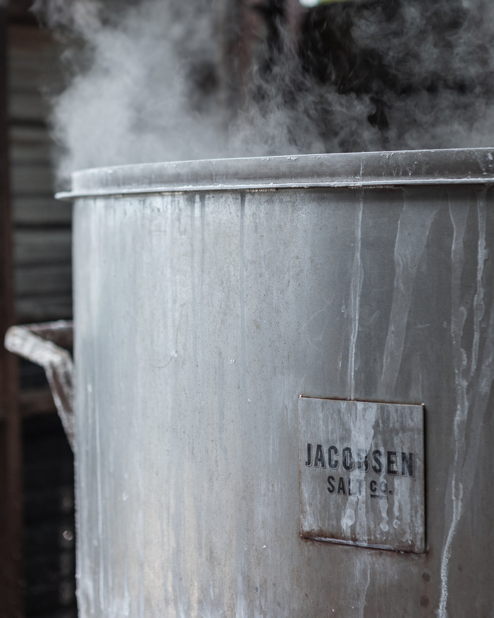 Large grey pot of boiling salt water with Jacobsen Salt Co logo on front.