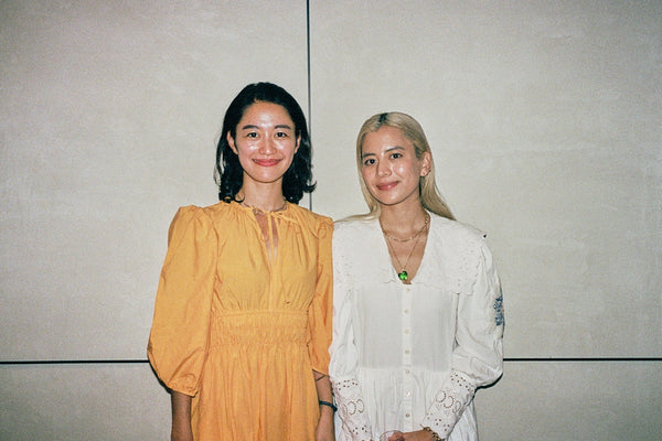 Two women, Miki Nomura and Eri Miyagi, stand side-by-side and smile at the camera.