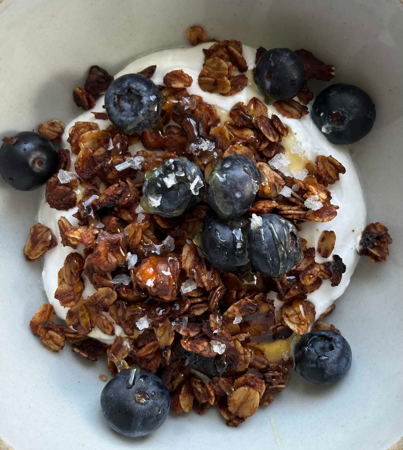 Granola and blueberries mixed in with yogurt.