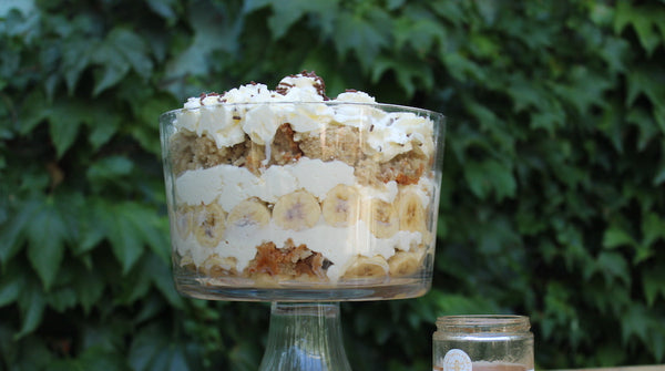 A glass jar containing banana trifle.
