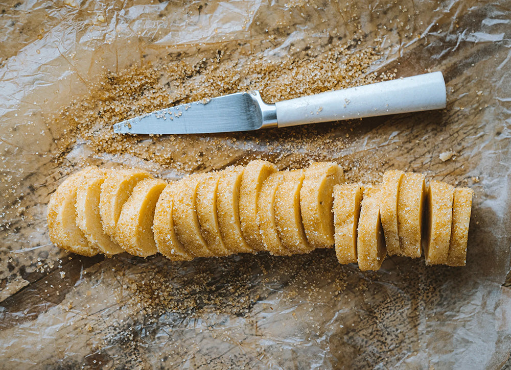Slices of cookie dough and a knife.