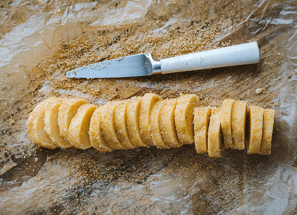 Slices of cookie dough and a knife.