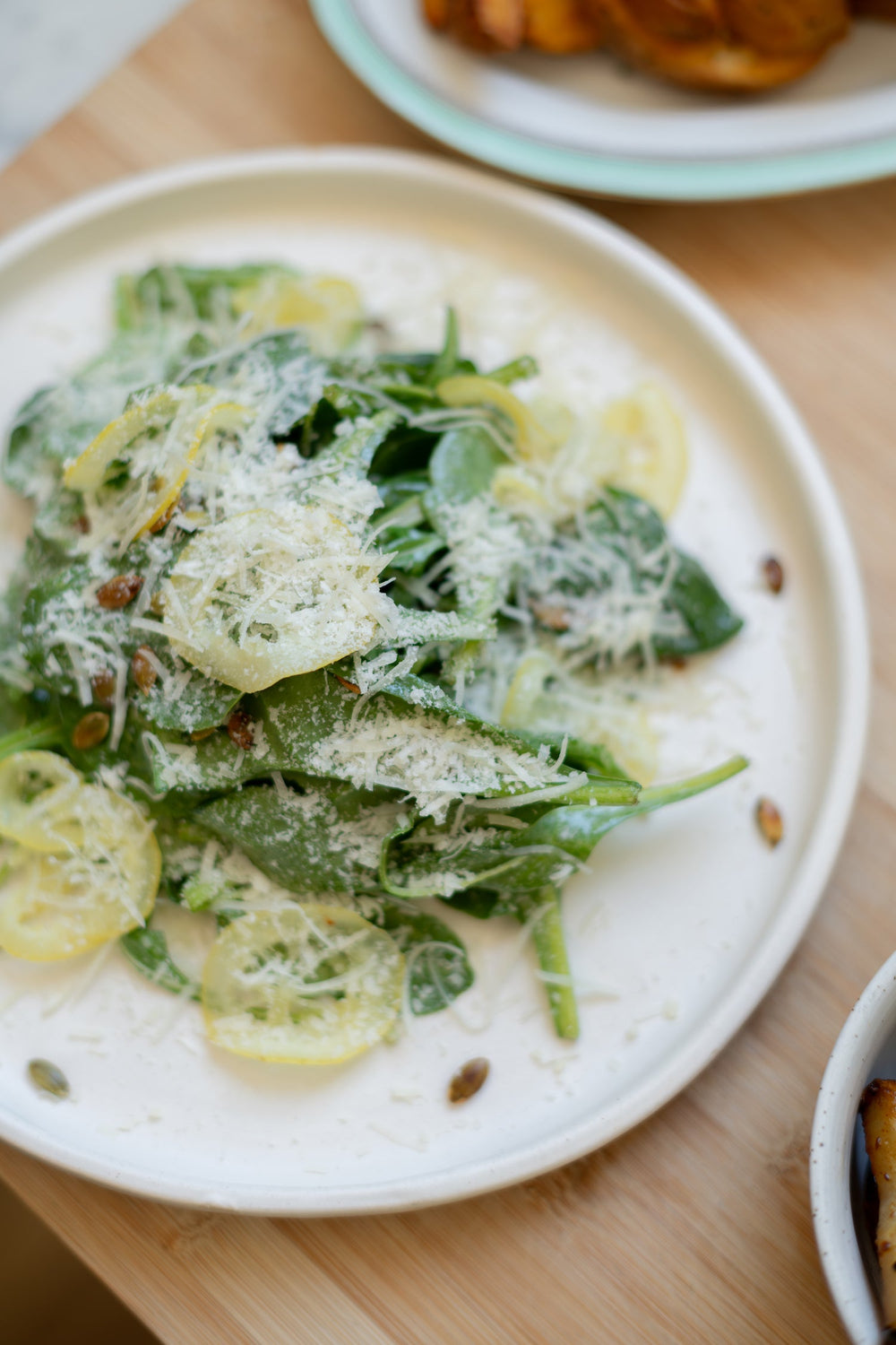Leafy salad topped with vinaigrette and grated cheese.