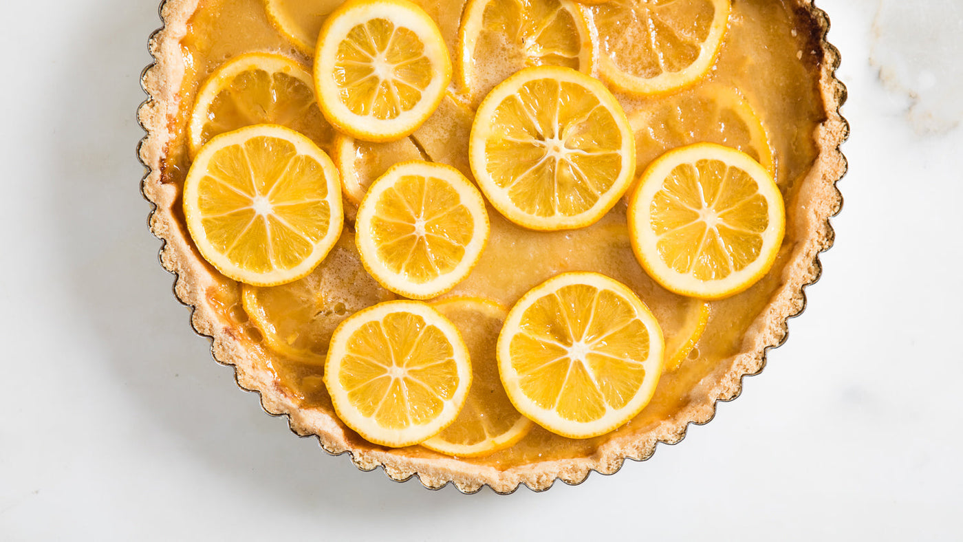 A lemon tart with slices of lemon on top.