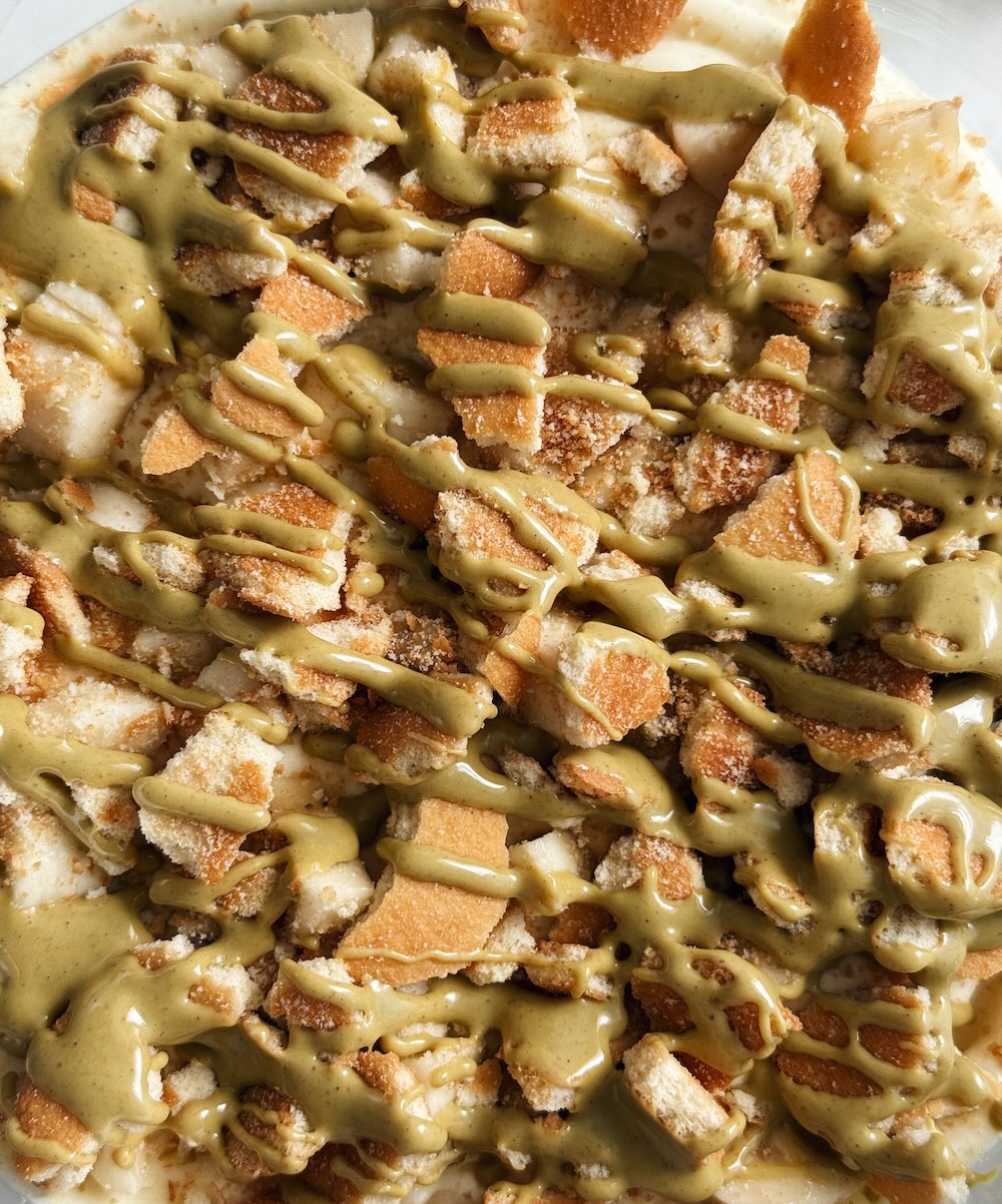 Pistachio pudding, with a mix of bananas, vanilla wafers and drizzled Pistakio spread.