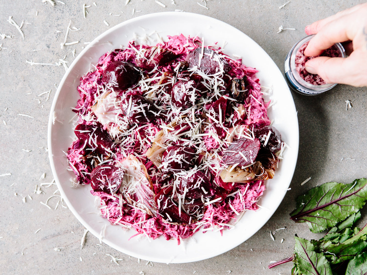 Plate of radicchio salad, being sprinkled with Pinot Noir Salt
