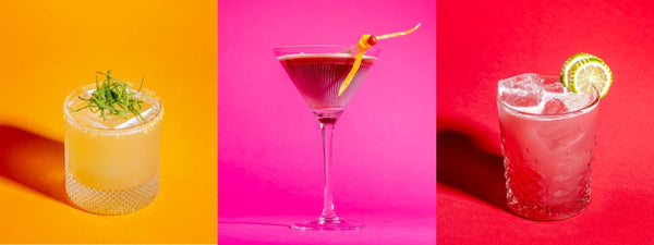 A triptych with three beverages. On the left is a glass with an orange drink and orange background, in the middle a pink drink and pink background, and on the right is a red drink and red background.
