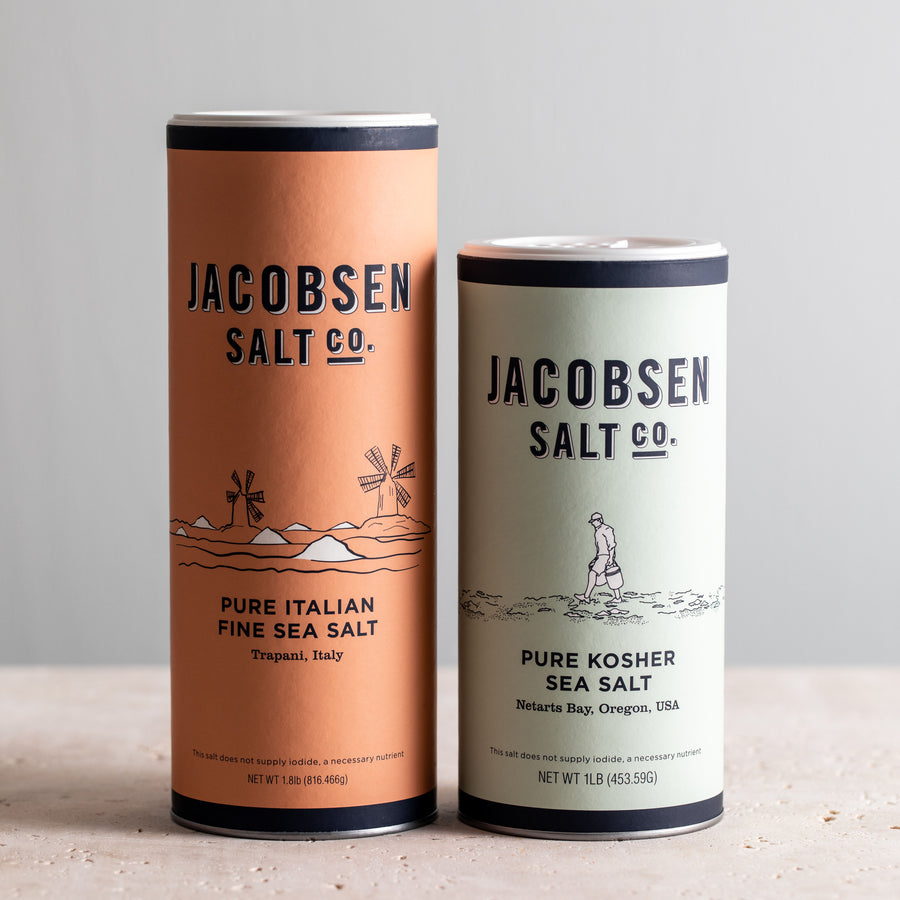 Two canisters of Jacobsen Sea Salt, 'Pure Italian Fine Sea Salt, and 'Pure Kosher Sea Salt'.