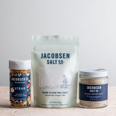 Jaocbsen Salt Co bundle, including a jar of Steak Seasoning, a bag of Pure Flake Salt and a Jar of Black Pepper Salt.