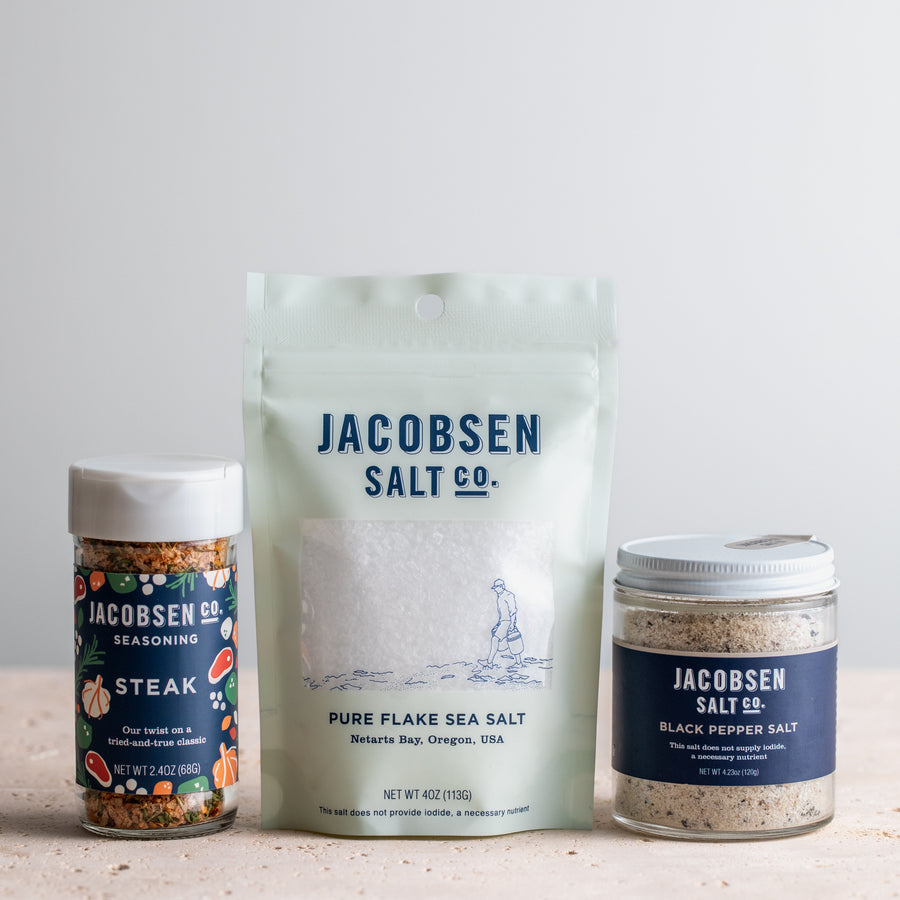 Jaocbsen Salt Co bundle, including a jar of Steak Seasoning, a bag of Pure Flake Salt and a Jar of Black Pepper Salt.