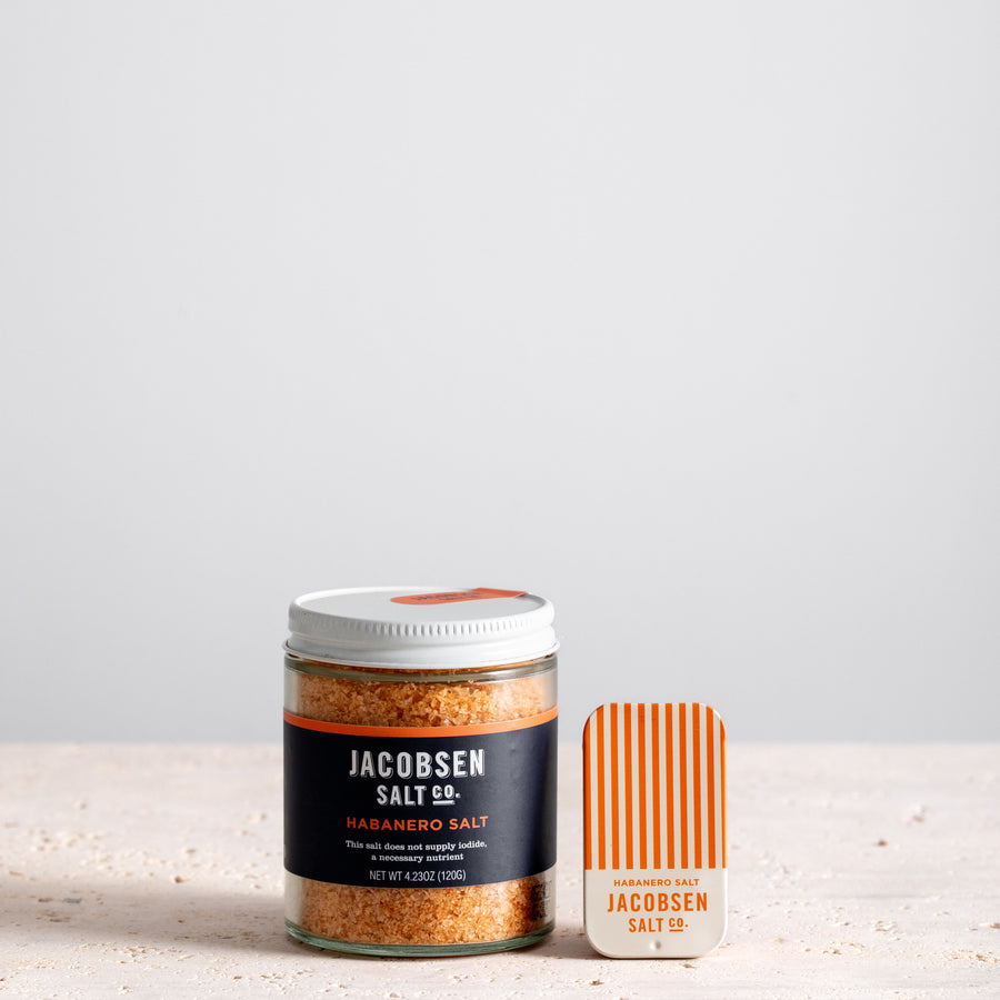 A jar of Jacobsen Infused Habanero Salt next to a matching slide tin of the same product. 