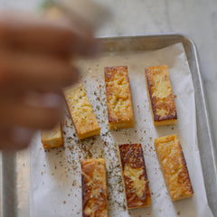 Adding Jacbosen Italian Seasoning to baked tofu.