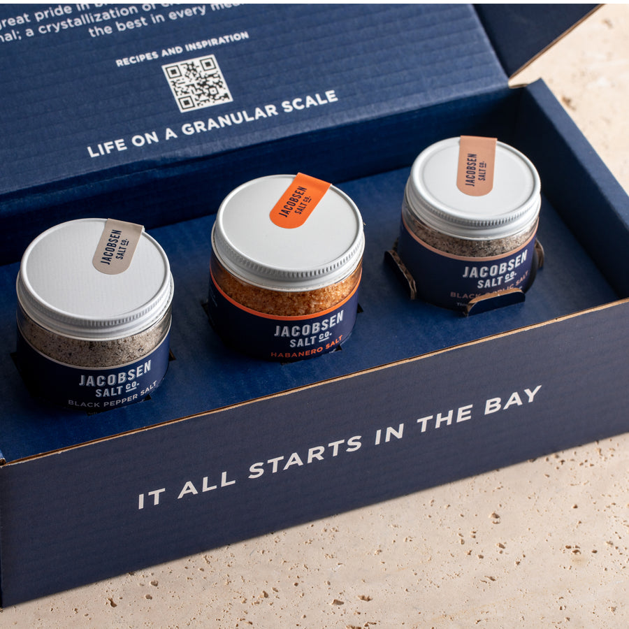 Open blue three pack bundle box, with Black Pepper, Habanero and Black Garlic Infused Sea Salts inside