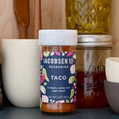 Jar of Jacobsen Taco Seasoning on pantry shelf.