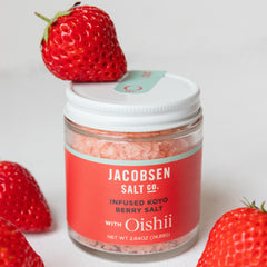 A jar of Jacobsen Infused Koyo Berry Salt, with koyo strawberries surrounding the jar.