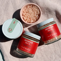 Three jars of Jacobsen Salt Co. with Oishii on a pink picnic blanket.