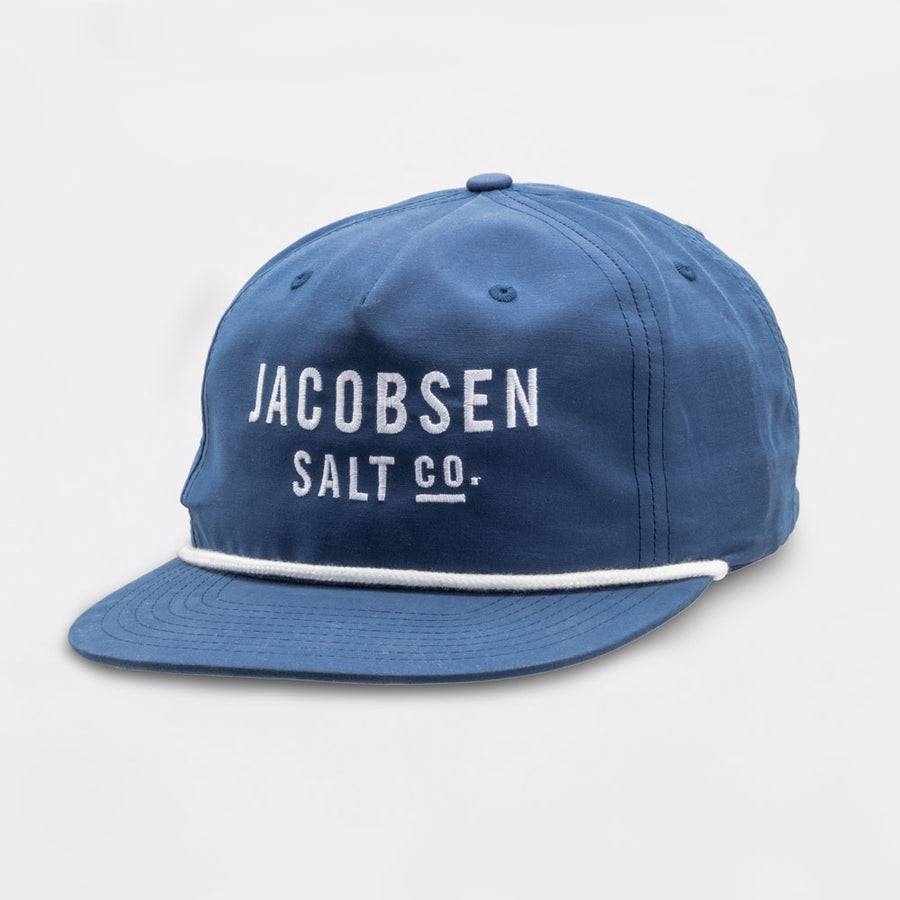 A blue hat with Jacobsen Salt Co in white on the front